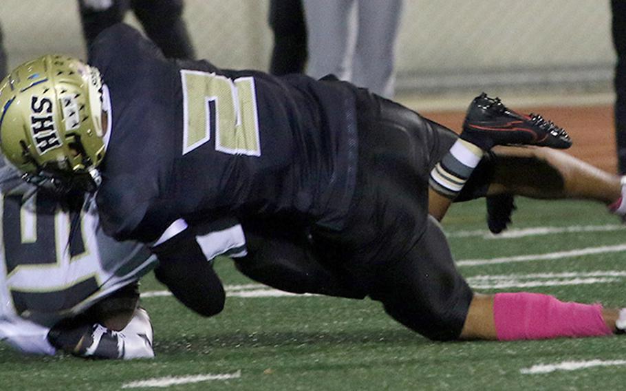 Humphreys Gold's Darryl Veal gets hauled down by Humphreys Black's Sean Cook.