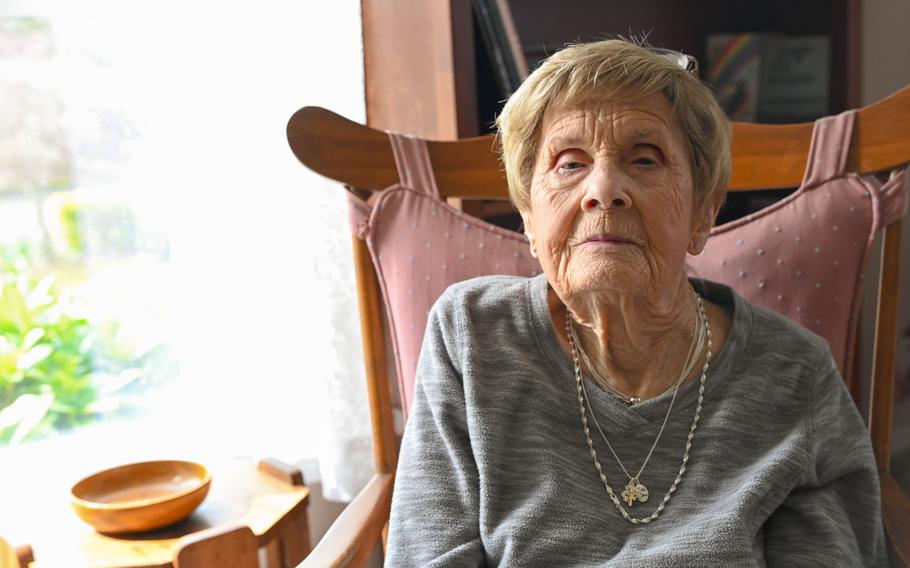 Peggy Lutz sits in a chair with sunlight pouring in through a window next to her.
