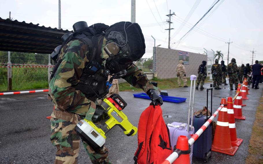 A Thai airmen checks for radioactivity among evacuees' personal belongings during a Cobra Gold drill in Rayong, Thailand, on March 3, 2024. 