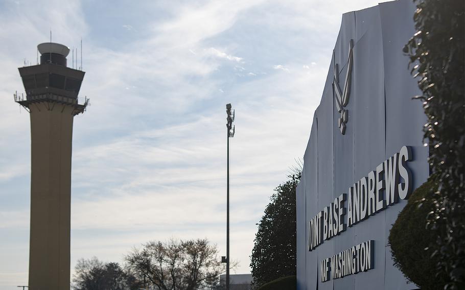 A Joint Base Andrews sign faces the air traffic control tower along the Maryland base’s flight line on Friday, Dec. 10, 2021.