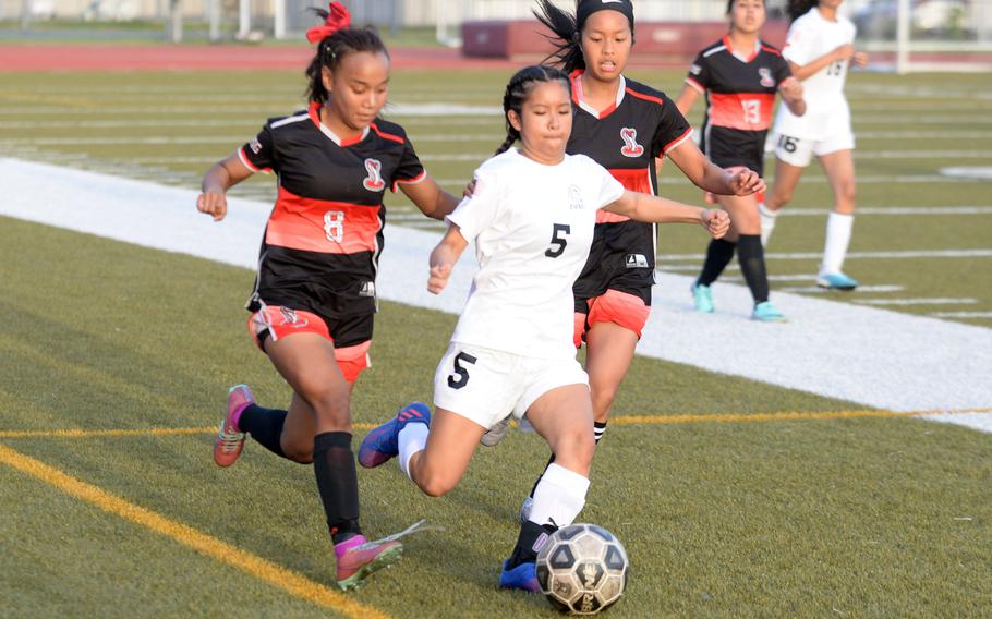 E.J. King’s Miu Best and Zama’s Lindsay Andrade chase the ball during Friday’s DODEA-Japan girls soccer match. The Cobras won 5-0.