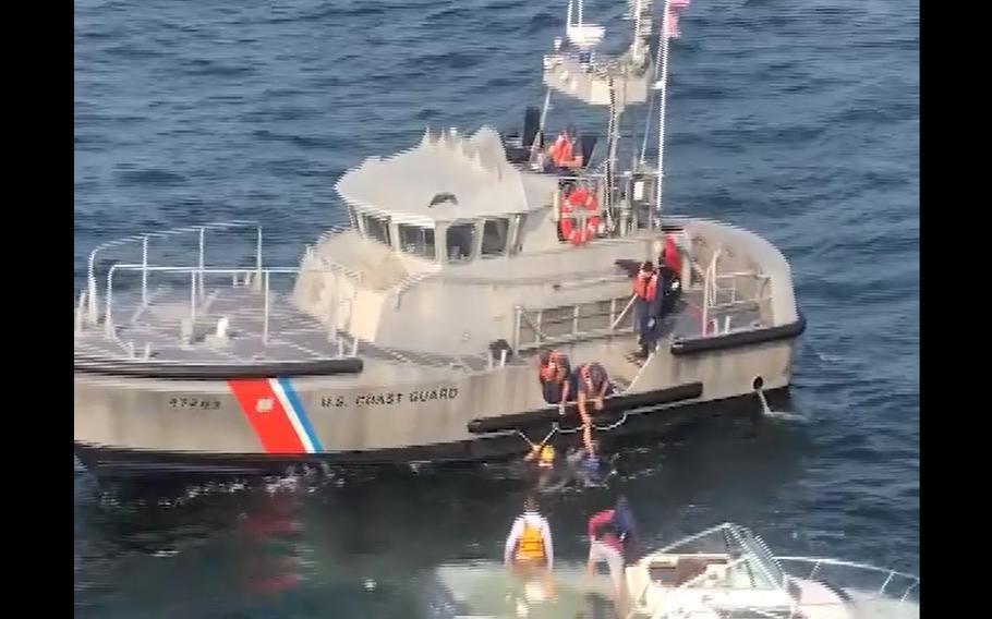 Coast Guard members rescue three people after their vessel began taking on water three miles east of Long Branch, Sept. 12, 2021. No injuries or medical concerns were reported.