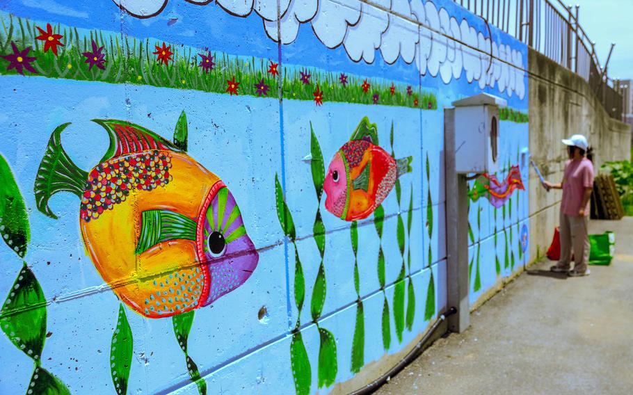 Humphreys High School junior April Conner adds finishing touches to a mural at Jacob's House, an orphanage near Camp Humphreys, South Korea, June 13, 2023.