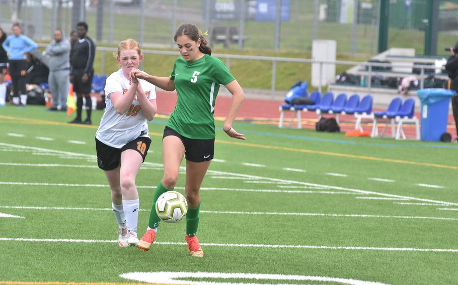 Spangdahlem's Samantha Moran and Alconbury's Sofia Politis battle with their hands and feet to get possession of the ball Tuesday, May 16, 2023, at the DODEA-Europe Division III girls championships at Ramstein Air Base, Germany.