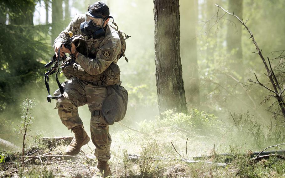 A soldier in a gas mask mid-run.