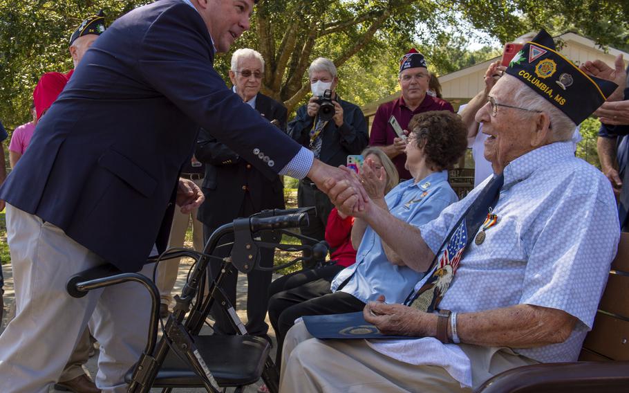 U.S. Rep. Steven Palazzo, R-Miss., awards a special challenge coin honoring Mississippi veterans to 98-year-old WWII veteran Henry "Howard" Bennett at the Collins State Veterans Home in Collins, Miss., on Thursday, Oct. 7, 2021. 