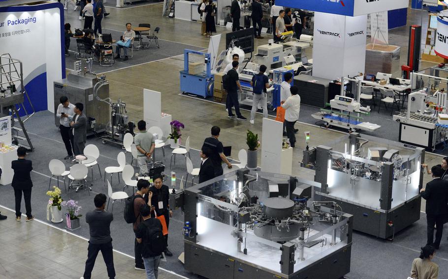 Visitors at a food conference look at new kitchen technology.