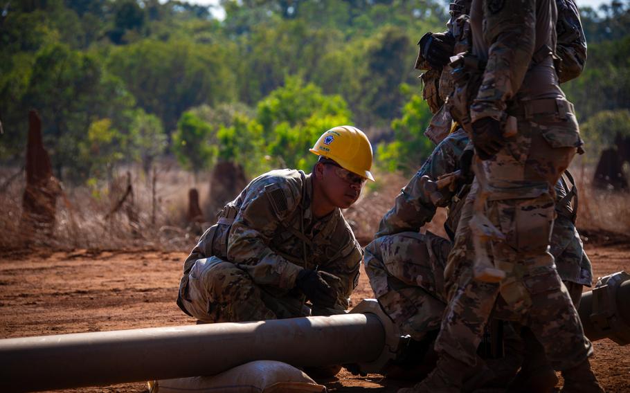 U.S. Army Pfc. Martine Flores, a vertical construction engineer with 555 Engineer Brigade, helps connect two pipes during a ship-to-shore fuel pipeline exercise in Weipa, Australia, July 20, 2023. The training was part of Talisman Sabre.