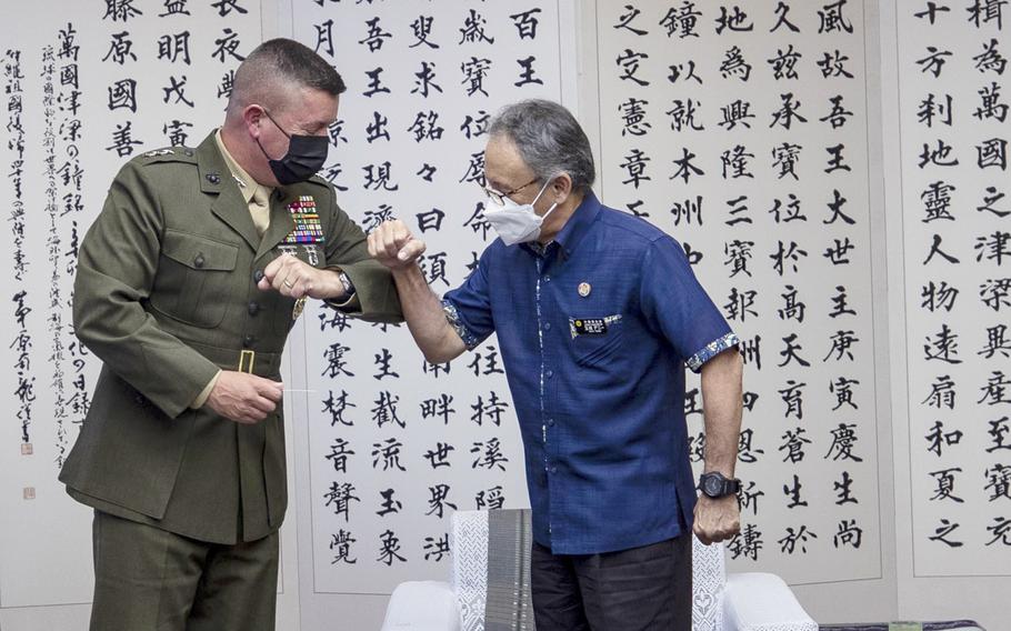 Marine Lt. Gen. James Bierman, left, greets Okinawa Gov. Denny Tamaki during a visit to the Okinawa prefectural offices in Naha, Okinawa, on April 12, 2022. 