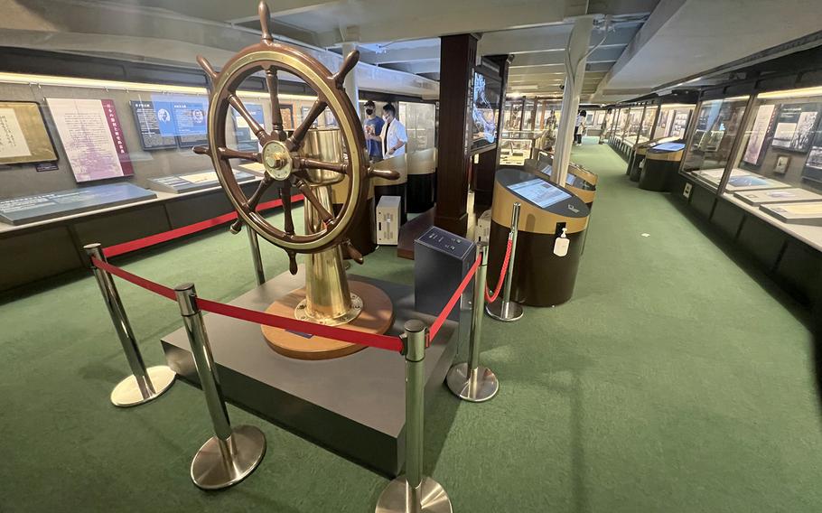 Artifacts, including the HMJMS Mikasa's original rudder wheel, are on display inside the ship ported in Yokosuka, Japan.
