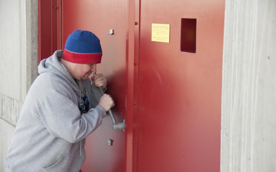 Sean Lohr, a contractor with Harris Corporation at Thule, opens an airlock into one of the radomes.