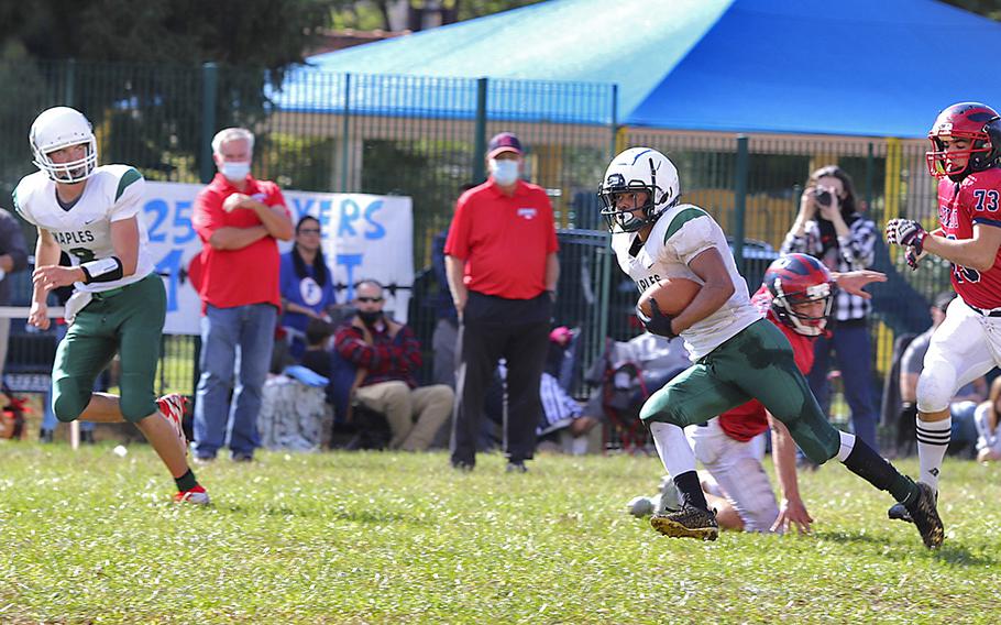 Naples’ Keith Rascoe Jr. runs past Aviano Saints’ defenders during Saturday’s football game held at Avianol. The Wildcats won the game decisively by the score of 40-0.