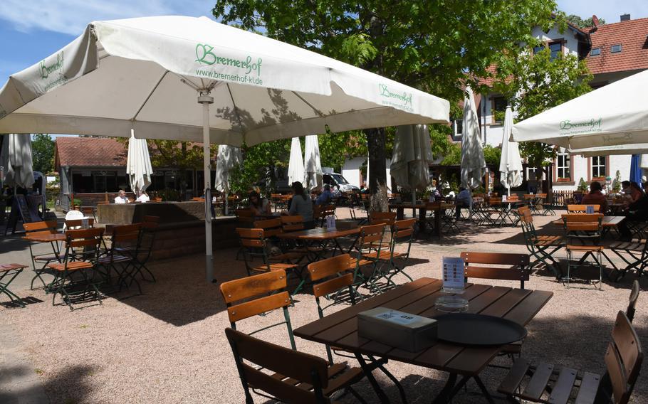 Customers enjoy the warm spring weather at the Bremerhof beer garden in Kaiserslautern, Germany.