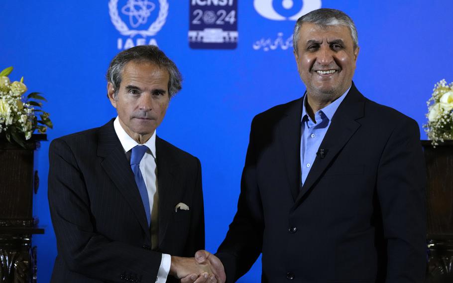 International Atomic Energy Organization, IAEA, Director General Rafael Grossi, left, and head of Iran’s atomic energy department Mohammad Eslami shake hands at the conclusion of their joint press conference after their meeting in the central city of Isfahan, Iran, Tuesday, May 7, 2024.