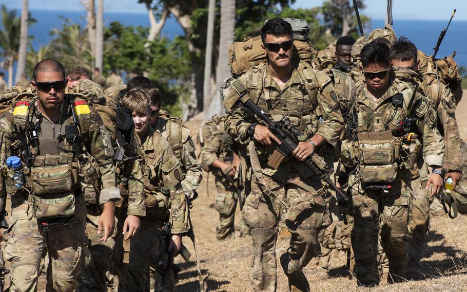 Soldiers with the 25th Infantry Division walk toward a CH-47F Chinook helicopter during a Balikatan air-assault drill on Batan Island, Philippines, May 5, 2024.