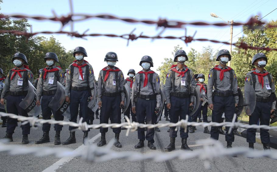 In this Nov. 11, 2020, file photo, police stand guard behind barbed wire as they attempt to stop protesters outside Union Election Commission office in Naypyitaw, Myanmar. After Myanmar’s military staged a coup Monday, Feb. 1, 2021, Aung San Suu Kyi finds herself back under house arrest. But this time, her standoff with the generals comes after she has sorely disappointed many once-staunch supporters in the international community. (AP Photo/Aung Shine Oo, File)