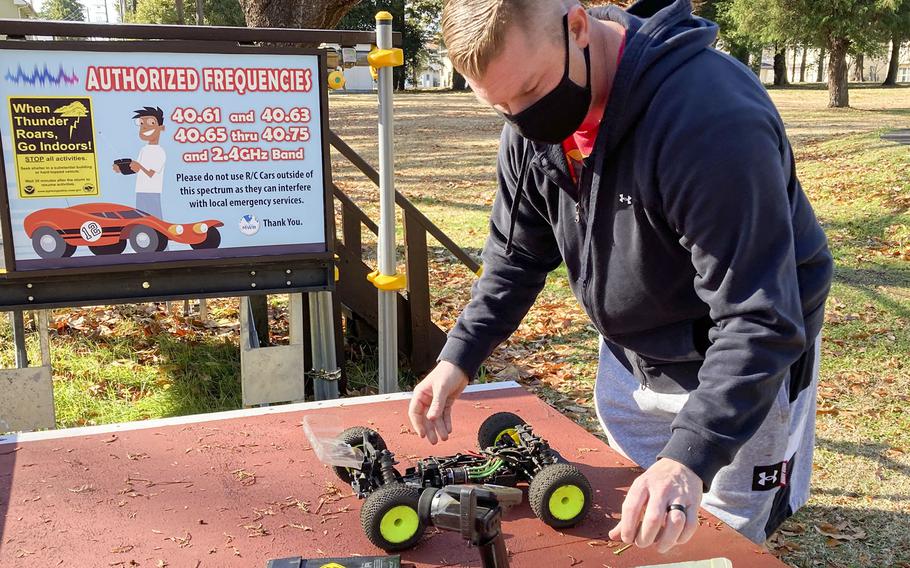 Chief Warrant Officer 4 Garrett Burns prepares his radio-controlled buggy to race on a new track at the Sagamihara Housing Area near Camp Zama, Japan, Dec. 9, 2021.