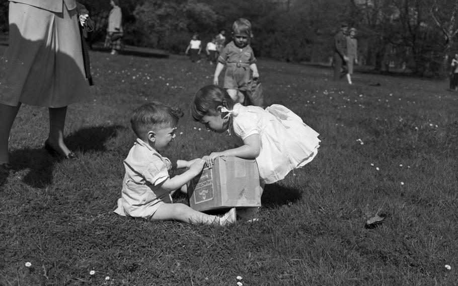 Two kids holding a box, one of them crying.
