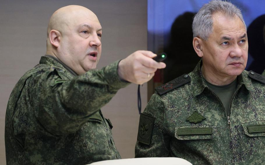 The top Russian military commander in Ukraine, Gen. Sergei Surovikin, left, and Russian Defense Minister Sergei Shoigu, center, attend the meeting with Russian President Vladimir Putin during his visit to the joint staff of troops involved in Russia’s military operation in Ukraine, at an unknown location, Saturday, Dec. 17, 2022.