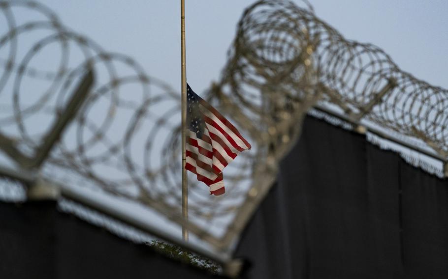 A flag flies at half-staff as seen from Camp Justice in Guantanamo Bay Naval Base, Cuba.