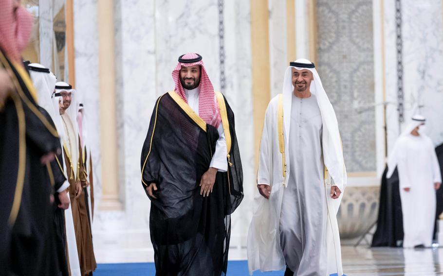 In this photo released by the state-run WAM news agency, Saudi Crown Prince Mohammed bin Salman, left, and Abu Dhabi’s powerful crown prince, Sheikh Mohammed bin Zayed Al Nahyan, walk into a reception in Abu Dhabi, United Arab Emirates, Tuesday, Dec. 7, 2021. After years of looking abroad, mainly to the West, for answers to regional problems, Middle East countries now appear to instead be turning inward, talking to each other about resolving long-running tensions and issues. 