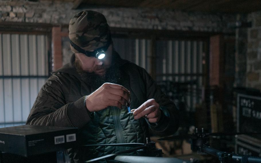 A member of Ukraine's 92nd brigade's drone unit repairs a Vampire attack drone.