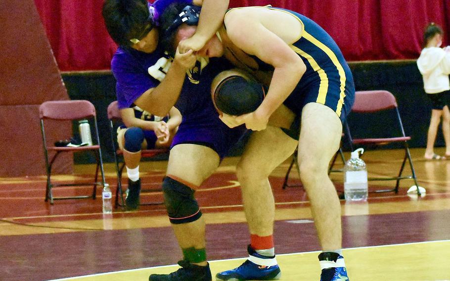 Guam High's Jack Ellis works a single leg hold en route to pinning George Washington's Jacob Blass in 1 minute, 19 seconds.