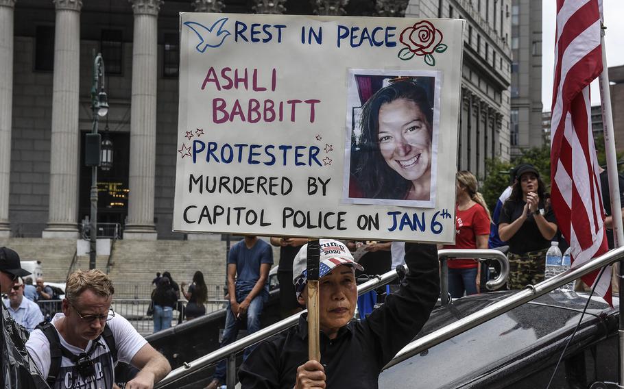 A protester holds a sign about Air Force veteran Ashli Babbitt while participating in a political rally on July 25, 2021, in New York City. 