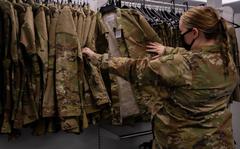 Senior Airman Quynn Santjer, Unit Deployment Manager for the 94th Fighter Squadron, looks through the new abundance of maternity options at Military Clothing Sales at Langley Air Force Base, December 2, 2021. Santjer was happy to know that her co-worker, who is newly pregnant, will not have to wait for uniforms to be shipped to her like she did.