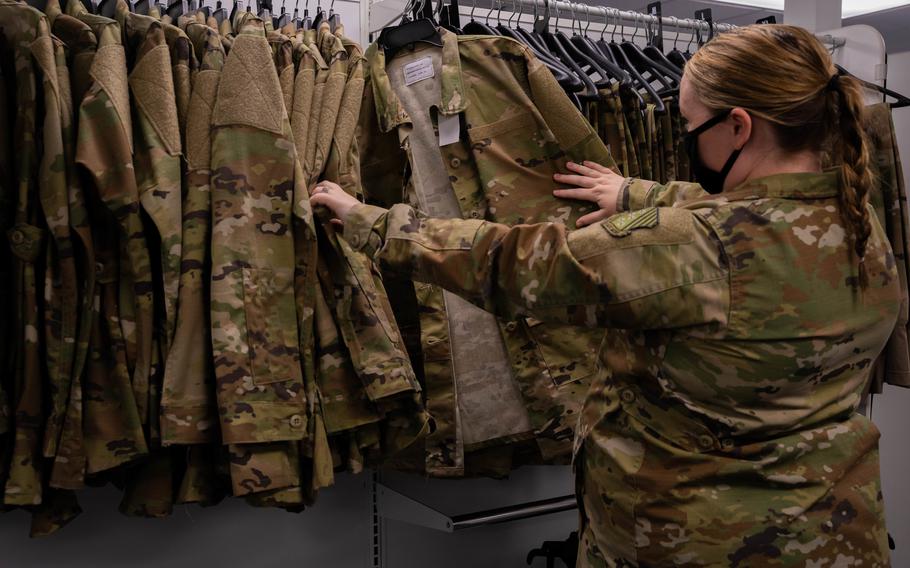 Senior Airman Quynn Santjer, Unit Deployment Manager for the 94th Fighter Squadron, looks through the new maternity options at Military Clothing Sales at Langley Air Force Base, Dec. 2, 2021. Pregnant airmen and guardians at 10 bases across the country and in Japan will soon be able to receive free maternity uniform items through the Maternity Uniform Pilot Program, or “Rent the Camo.”