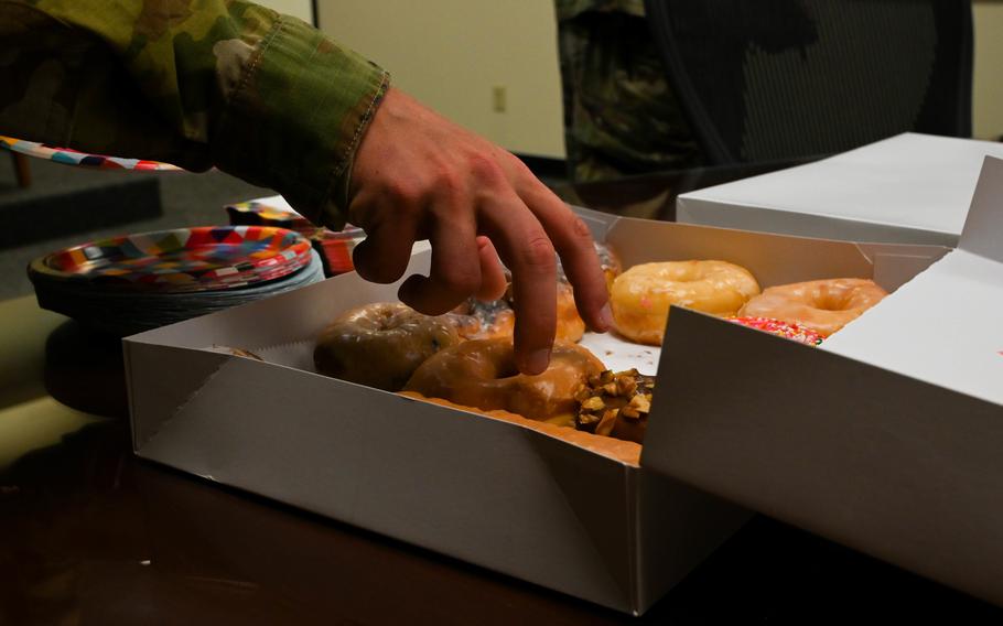 A service member reaches for a donut at Altus Air Force Base in Oklahoma on July 29, 2021. Almost 75% of active-duty soldiers were found to be overweight during a nine-month study period amid the COVID-19 pandemic, a newly published report said.