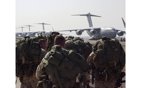 Aviano Air Base, Italy, Mar. 26., 2003: Members of the 173rd Airborne Brigade move toward C-17 transport planes on the taxiway at Aviano Air Base, Italy. The Vicenza-based troops parachuted into northern Iraq the same day as part of Operation Iraqi Freedom. 

Read the article on the mission here.
https://www.stripes.com/news/pilots-tell-of-harrowing-drop-of-173rd-1.3527

META TAGS: Operation Iraqi Freedom; War on Terror, Iraq; U.S. Army; U.S Air Force; 173rd Airborne Brigade; C-17; 62nd Air Wing; 7th Airlift Squadron