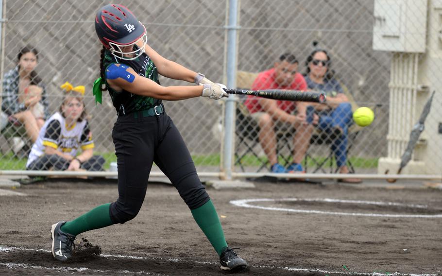 Kubasaki's Taylor Tobin makes contact against Kadena during Tuesday's Okinawa softball regular-season finale. The Panthers won 14-1 and wrapped up an unbeaten 8-0 regular season against the Dragons.