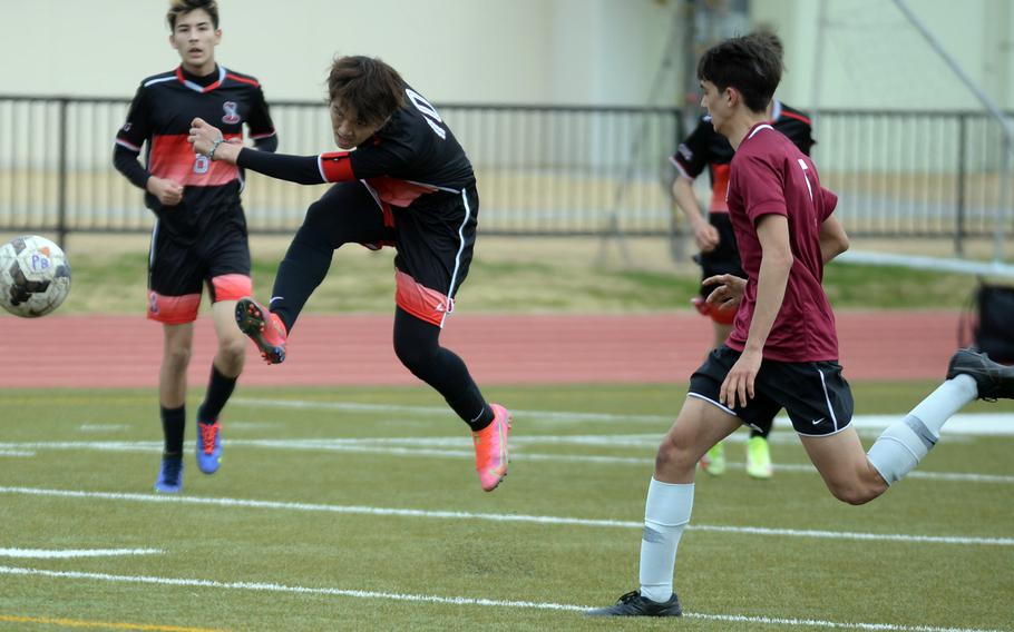 E.J. King's Kyo Tominaga launches a shot as Matthew C. Perry's John Shaver races over to defend during Friday's Perry Cup soccer matches. The Samurai won 2-0.