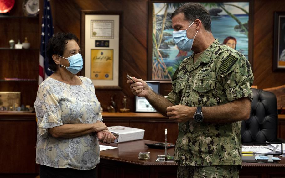 Guam Gov. Lou Leon Guerrero receives a coin from then-U.S. Pacific Fleet commander Adm. John Aquilino at her office in Adelup, Guam, May 2, 2020. Aquilino now heads U.S. Indo-Pacific Command. 