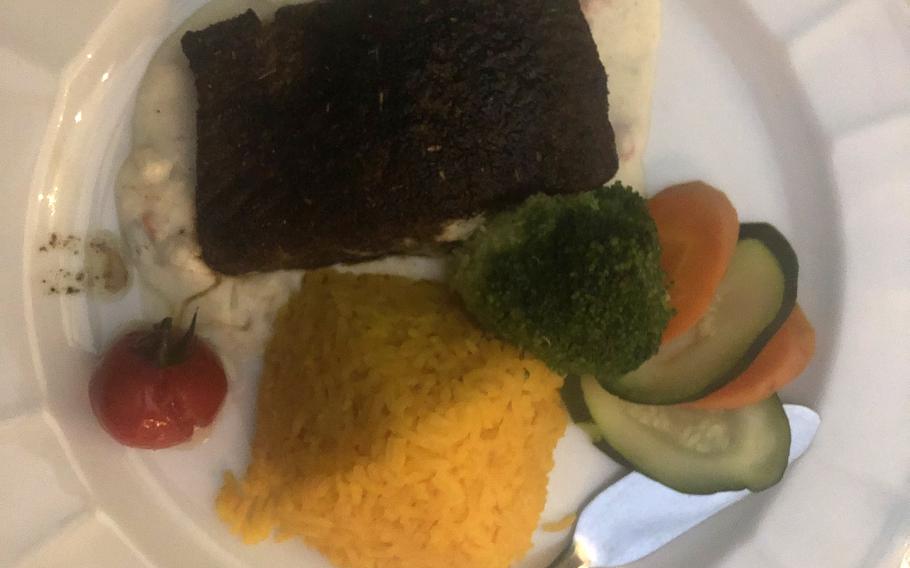 Blackened salmon with Cajun seasoning served with a pyramid of rice and vegetables, at Julien restaurant in Kaiserslautern, Germany.