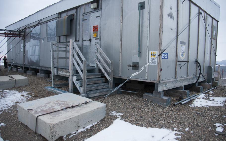 A retired radar on South Mountain near Thule Air Base, Greenland, was secured to the ground with steel cables. Wind can reach speeds of more than 200 miles per hour with little warning.