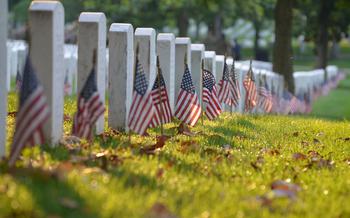 Members of the 3rd Infantry Regiment, also known as The Old Guard, place flags at the graves of those buried at Arlington National Cemetery for “Flags In” on Thursday, May 23, 2024, to honor fallen service members for Memorial Day. The annual event takes four hours for nearly 1,500 soldiers, including about 100 joint service members, according to Arlington National Cemetery.  