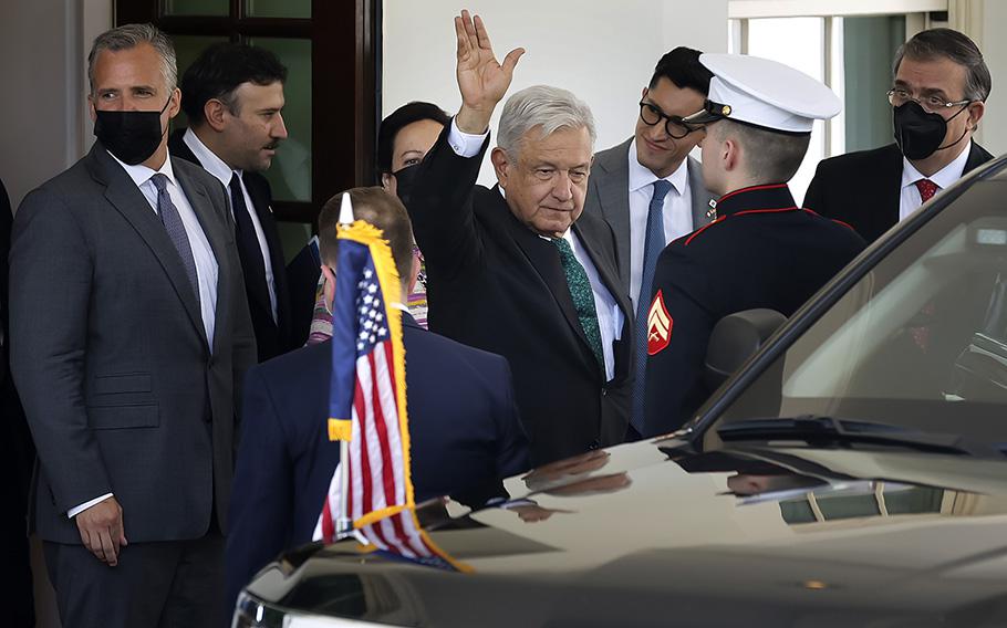 Mexican President Andres Manuel Lopez Obrador waves to journalists as he departs the White House following a meeting with U.S. President Joe Biden on July 12, 2022, in Washington, DC. 