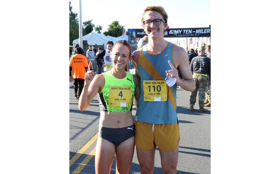Army 10-Miler women’s division winner Jenny Simpson poses for a photo with men’s division winner Luke Peterson after Sunday’s race at the Pentagon.
