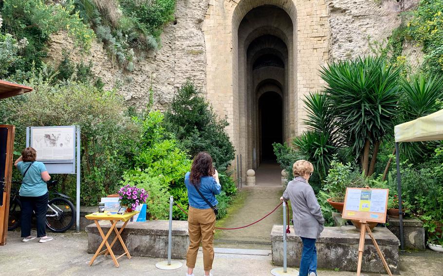 Visitors gather at the entrance to the Grotto di Seiano for guided tours of the Parco Archeologico del Pausilypon in Naples, Italy. Access to the park is only allowed with a guide. 