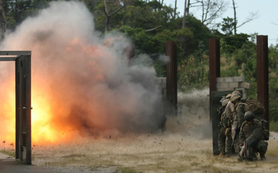 Reconnaissance and explosive ordnance disposal Marines take cover from a blast while training at Camp Hansen, Okinawa, in 2008. 