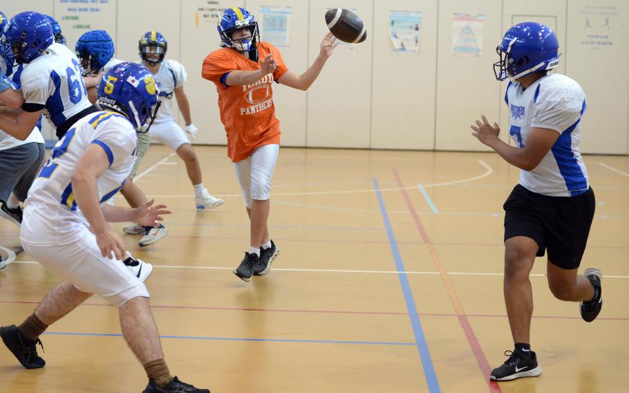 Yokota players practice plays in the gym.