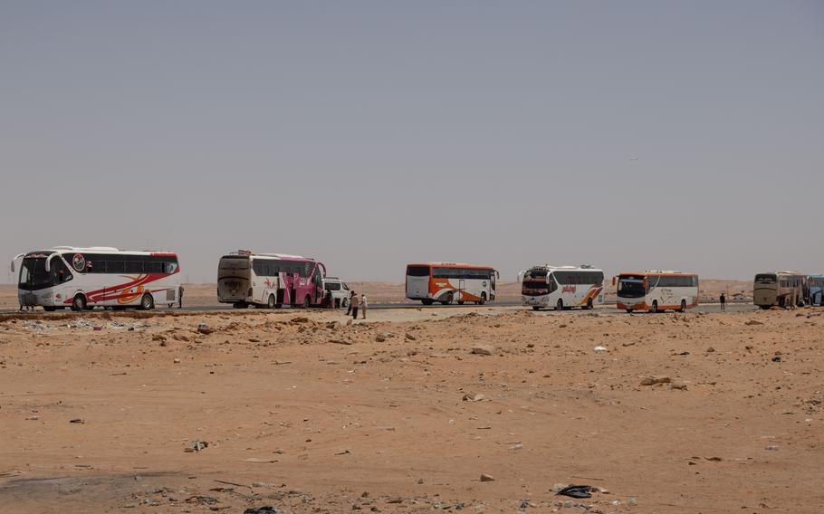 Buses outside a bus stop near Aswan, Egypt, on April 27, 2023. Some Sudanese who can afford the trip are traveling to Egypt to escape the conflict at home.