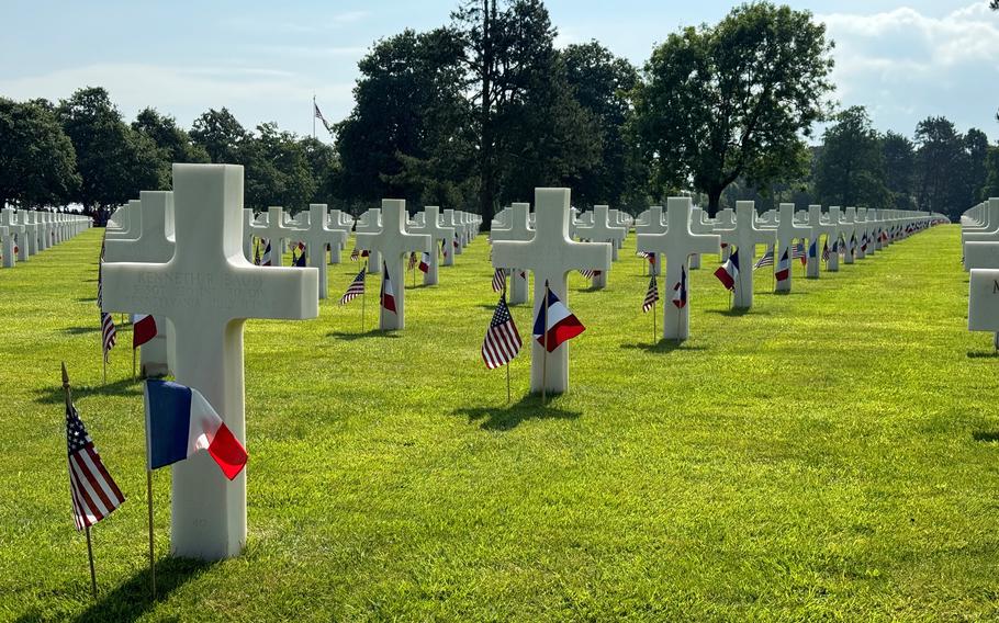 U.S. and French flags decorate graves of American dead at the Normandy American Cemetery in Colleville-sur-Mer, France, June 6, 2024.