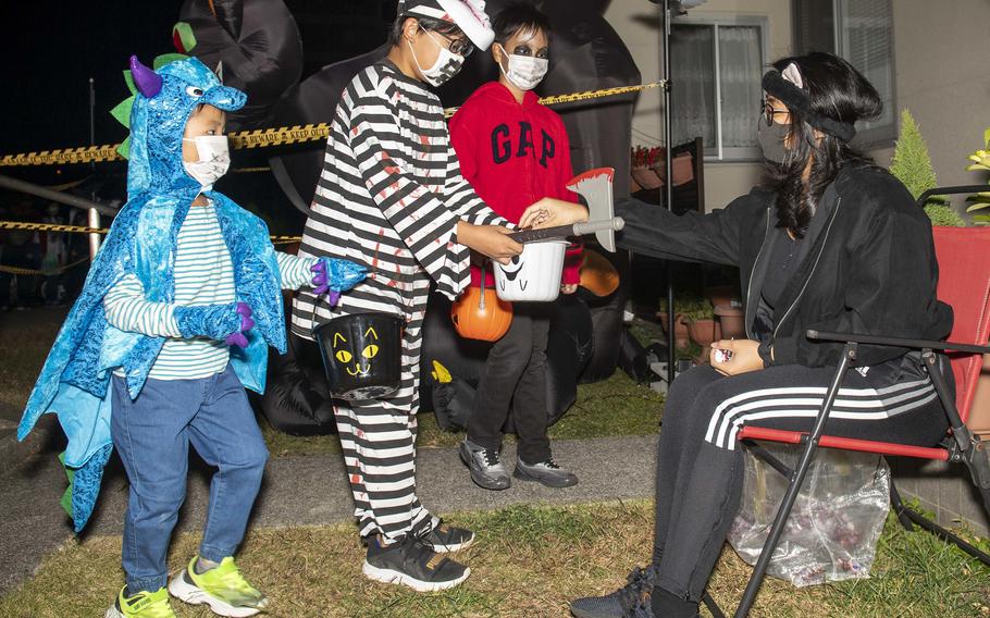 Trick-or-treaters collect candy at the Dragon Vale housing area near Sasebo Naval Base, Japan, Oct. 31, 2021.