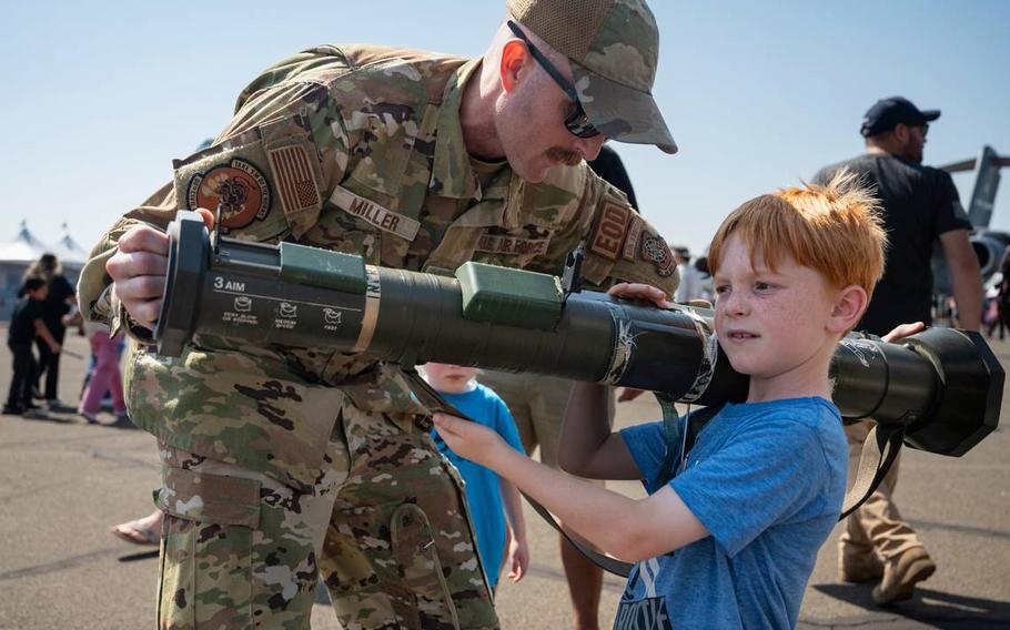 U.S. Air Force Tech Sgt. Joel Miller helps William Hoyt, 7, hold an AT4 anti-tank weapon at the California Capital Airshow on Sept. 24, 2023, at Mather Airport.