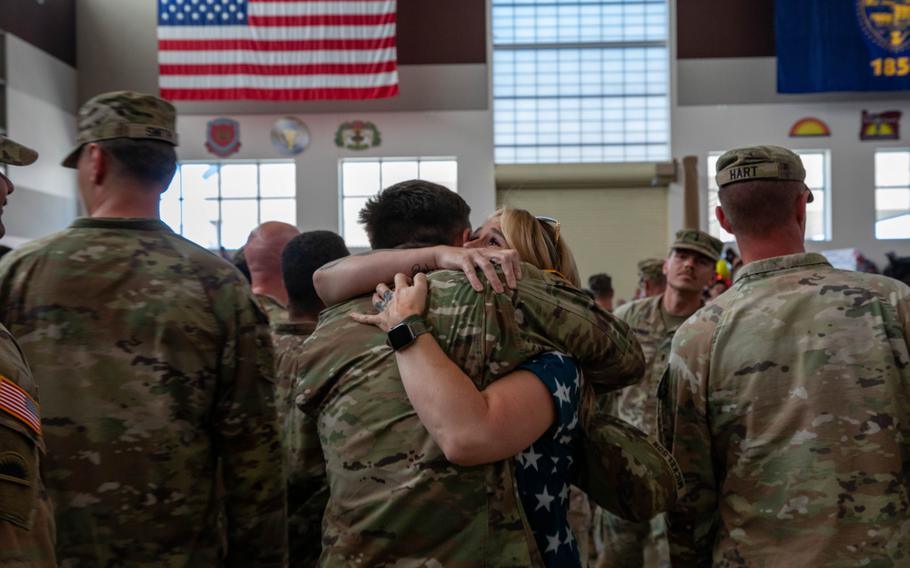 A soldier receives an embrace on his return home.