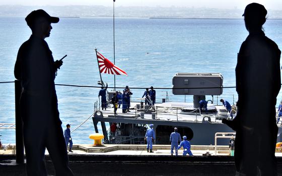 A Rising Sun flag flies from the Japanese destroyer JS Yuugiri near Okinawa, April 22, 2018.