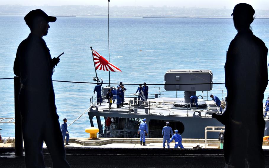 A Rising Sun flag flies from the Japanese destroyer JS Yuugiri near Okinawa, April 22, 2018.